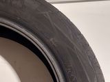 a close up of a tire on a white surface with a black rim