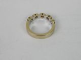 a close up of a gold ring on a white surface