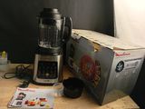 a blender sitting on a table next to a box of food