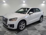 a white audi suv parked in a garage with a checkered floor