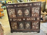 a large wooden chest of drawers in a store