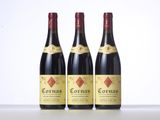 three bottles of red wine sitting on top of a table