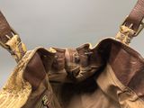 the inside of a brown purse with a zipper on it