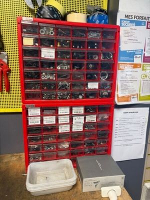 many different types of tools in the red bins
