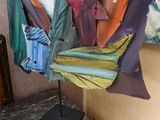 une sculpture représentant un poisson, réalisée en tissu et posée sur un socle