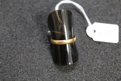 a ring that is sitting on top of a black object