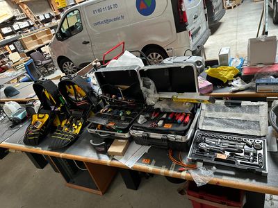 a table with a lot of electronics and tools on it