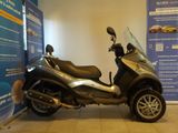 a scooter that is parked next to a wall