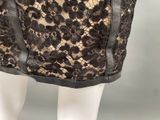 a close up of a mannequin dress with black lace on it