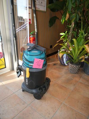 a vacuum that is sitting on the floor in front of a door
