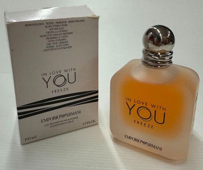 an image of a bottle of perfume next to a box