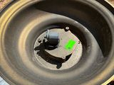 a metal bowl with a green arrow on it