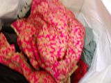 a pile of clothes in a plastic bag on the floor