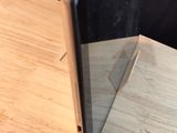 a black phone sitting on top of a wooden table