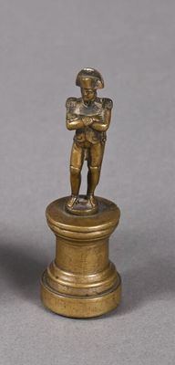 pair of bronze figurines of a boy and a boy on a pedestal