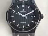 the watch is black and has a black dial on the face