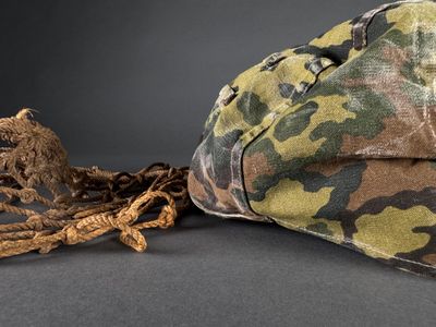 a camouflage hat and a rope on a table