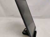 a close up of a tablet computer on a stand on a white surface