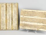 two pieces of marble on stands, one of which has been painted gold and the other of which has been