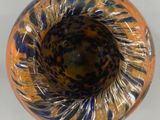 a close up of a glass vase on a white surface