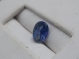a blue sapphire stone sitting on a white ring