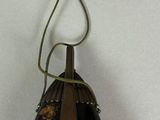 a picture of a black and gold object with a spider on it