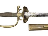 a sword that is laying on the ground next to a tube