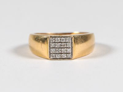 a close up of a gold and diamond ring on a white background