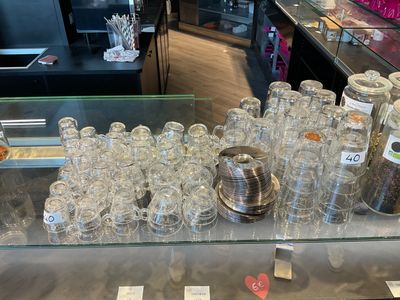 a glass counter with a lot of empty glasses on it