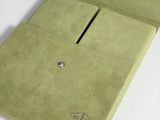 a green wallet with a diamond on it sitting on a table