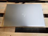 a laptop sitting on a wooden pallet on a table