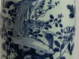 a blue and white vase with a bird on it