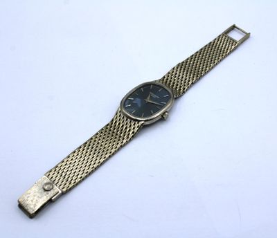 a close up of a wrist watch on a white surface