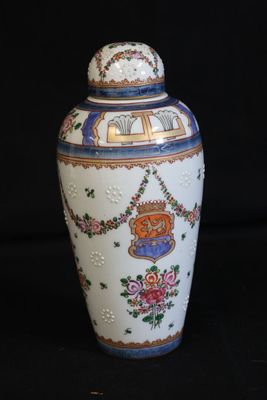 a white vase with a blue and red design on it