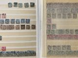 a lot of stamps on display in a glass case