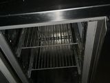 a black counter top with a silver oven inside of it