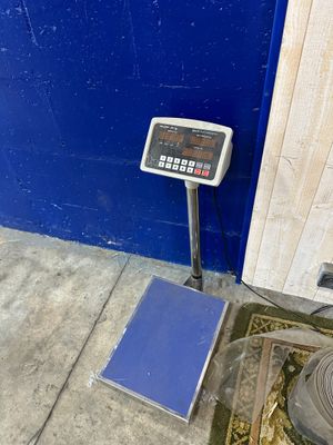 a scale on the ground next to a blue wall