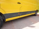 a yellow van that is parked on the side of the road