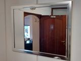 a mirror on the wall above a sink in a bathroom