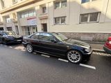 cars parked on the side of the road in front of a building