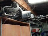 a pile of junk sitting on top of a shelf in a garage