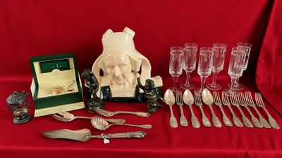 a table with silverware and a picture frame on it