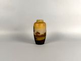 a small vase that is sitting on a white surface
