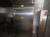 a stainless steel refrigerator in a kitchen next to a stove