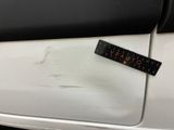 a sticker on the door handle of a white car
