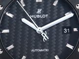 a close up of a watch with a black dial
