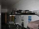 a picture of a kitchen with a bunch of dishes on the counter