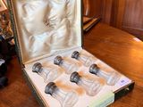 six bottles of wine in a case sitting on a table