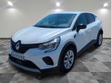 a white car parked in a room with a checkered floor