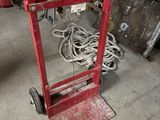a red hand truck that is sitting in a garage